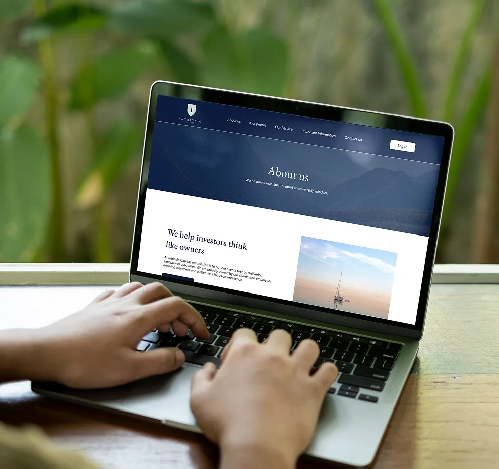 The Intrinsic Capital website shown on a laptop