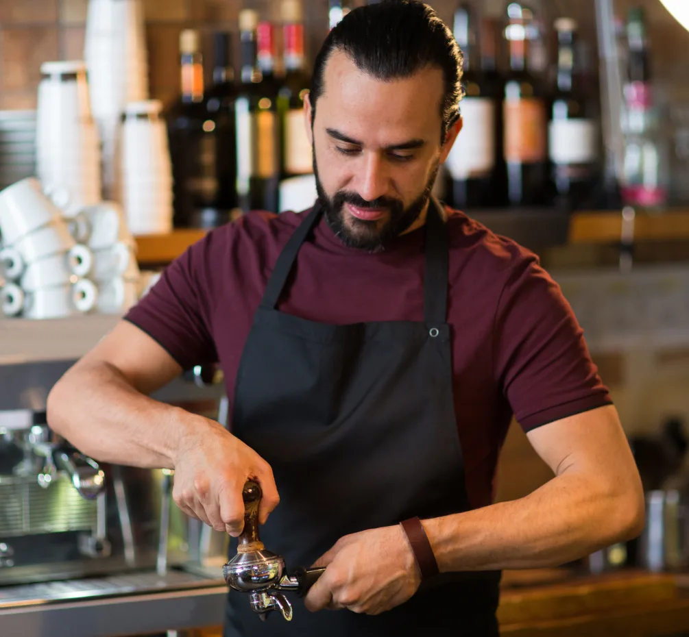 A Rolling Bean barista making coffee at an event
